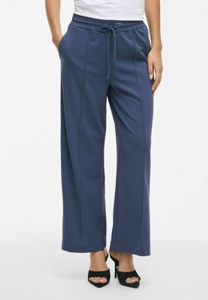 Navyblauwe wijde pantalons met een broekband met trekkoord, zijzakken, een gladde textuur en verticale naden aan de voorkant.