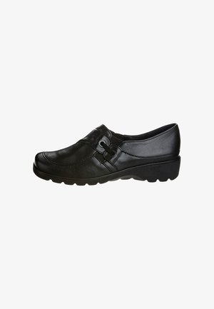 Black low-heeled leather slip-on shoe with elastic side panels, decorative stitching, and round rubber sole for casual or work wear.