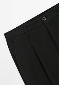 Black tailored trousers with a smooth texture, featuring a button closure, pleats at the front, and a fitted waistband.