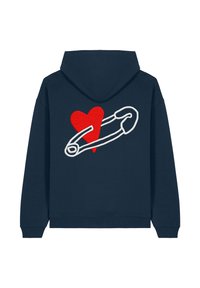 Felpa navy con un grande contorno bianco di una spilla di sicurezza e un cuore rosso ricamato sulla parte posteriore. Tessuto morbido e strutturato con polsini a costine.