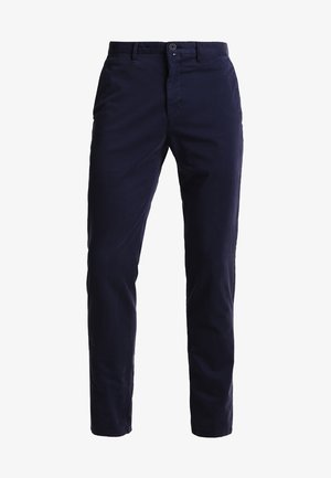 Chino de culoare albastru marin realizat dintr-un amestec de bumbac, cu un design drept, buzunare frontale, închidere cu fermoar și un cu talie cu un singur nasture.