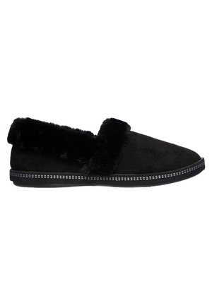 Black slip-on slippers with a soft faux fur collar, suede upper, and textured black sole featuring decorative stitching along the edge.