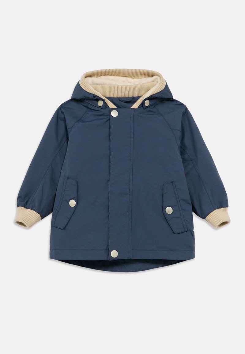 Μπλε σκούρο μπουφάν με μπεζ επένδυση στο καπό, κουμπιά με πατητό κούμπωμα και πλαϊνές τσέπες. Διαθέτει ριμπ μανσέτες και ελαφρώς κυρτή γραμμή στο τελείωμα.