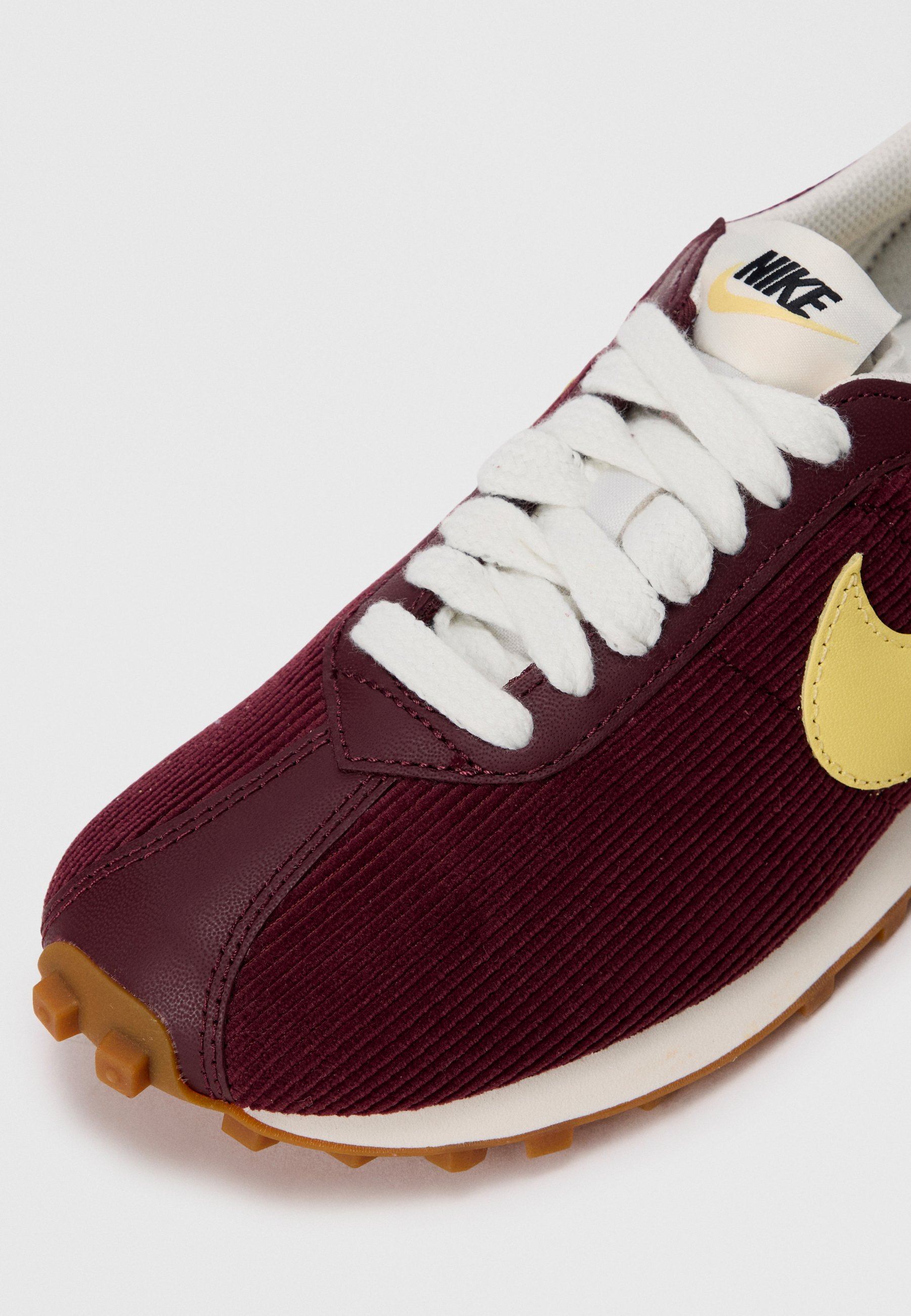 burgundy and yellow nike