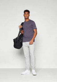 Harmaa lyhythihainen t-paita, vaaleanharmaat collegehousut ja valkoiset lenkkarit. Musta olkalaukku. Yksinkertainen muotoilu ja mukava istuvuus.