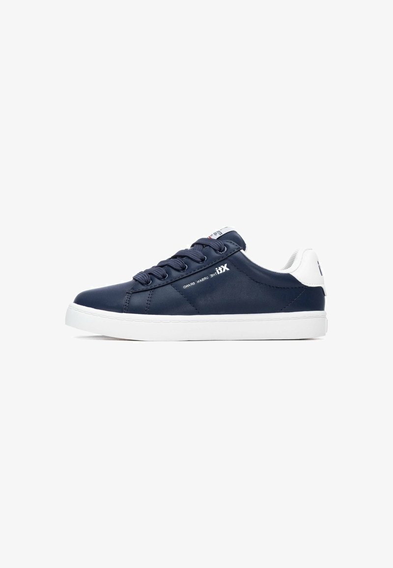 Zapatilla azul marino con material sintético liso, suela de goma blanca y detalles texturizados; presenta cordones redondos y acentos de logo.