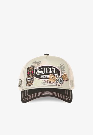 Beige and black Von Dutch baseball cap with stitched tiki face, winged eyeball, and "Von Dutch California" logo on front panel.