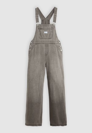 Grijze denim overall met verstelbare bandjes, een voorkantzak, zijknopen en een recht gesneden ontwerp. De stof heeft een vervaagde textuur.