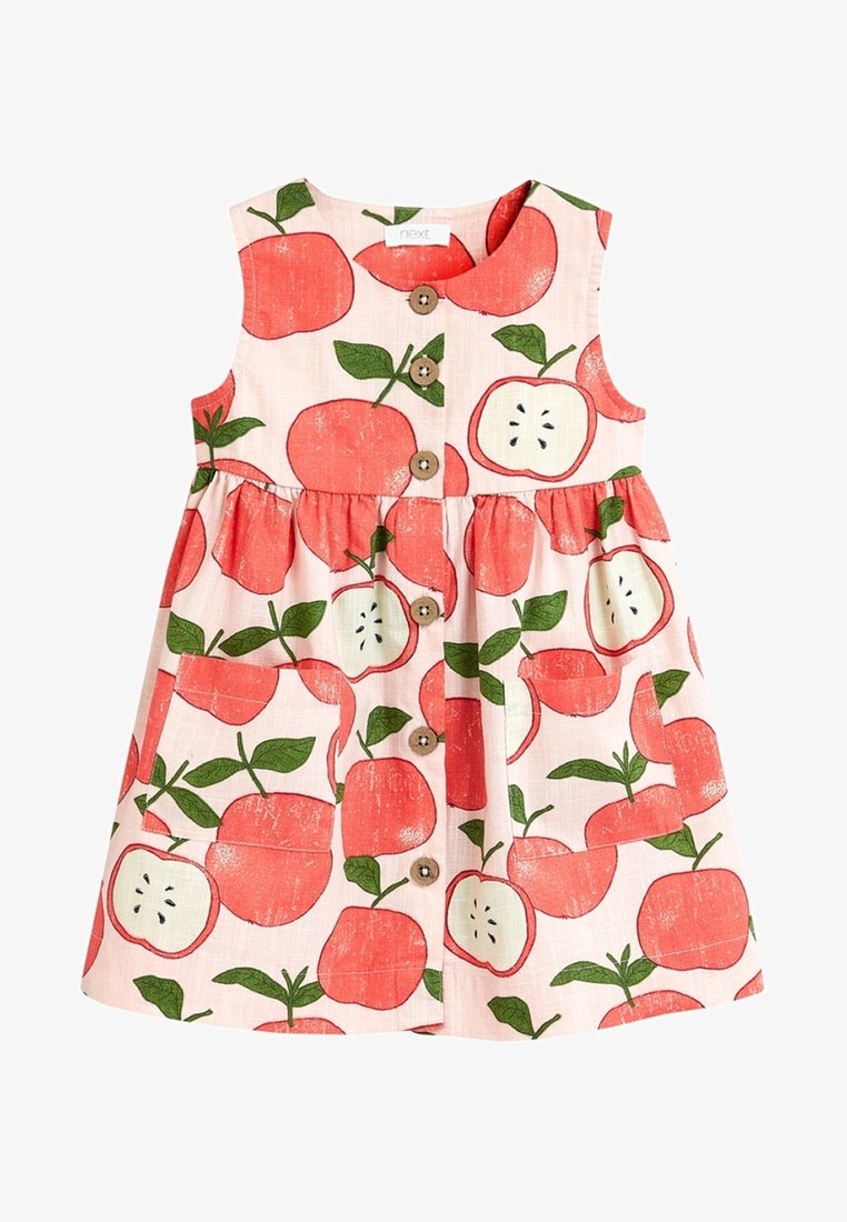 Robe sans manches pour tout-petit avec boutons à l'avant et motif pommes rouges avec feuilles vertes sur fond rose clair.