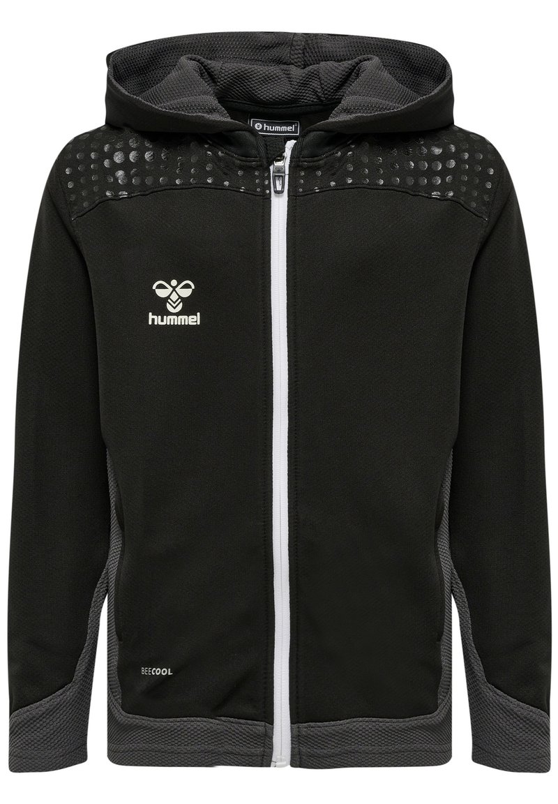 Felpa nera con zip, dettagli grigi, pannelli testurizzati e dettaglio a pois sulle spalle. Presenta una zip bianca e il logo 'hummel' sul petto.