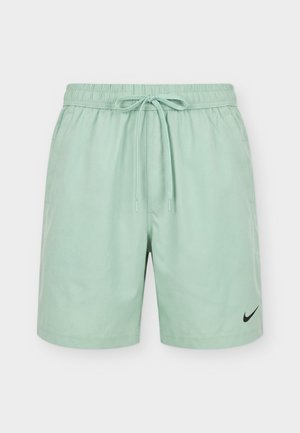 Short de sport vert menthe avec taille élastique, cordon de serrage, poches latérales et logo Nike swoosh noir sur la jambe gauche.