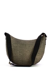 Textured hobo bag in black and cream, featuring a rounded shape, adjustable black strap, and a discreet metallic hardware accent.