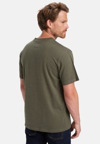 Olive green short-sleeve t-shirt with a crew neck and a subtle speckled texture, featuring a straight hem and relaxed fit.