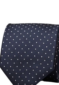 Marinblå slips i mjuk tyg, med ett upprepat mönster av små vita prickar på en strukturerad bakgrund.