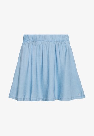 Light blue, knee-length skirt with gathered elastic waistband and small round metallic logo near hem on the right side.