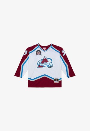 Maglia da hockey bianca e bordeaux con accenti blu, logo di montagna sul davanti e numero 33 sulle maniche.
