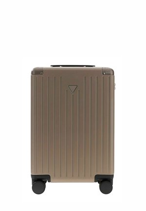 Valise rigide compacte avec rainures verticales, quatre roues noires et petit logo en haut à droite.
