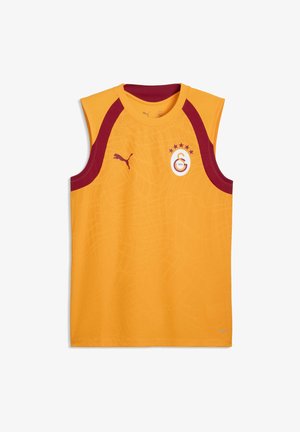 Koszulka sportowa bez rękawów w żółtym kolorze z bordowym obszyciem, logo Puma po prawej stronie klatki piersiowej oraz emblem klub piłkarski Galatasaray po lewej stronie klatki piersiowej.