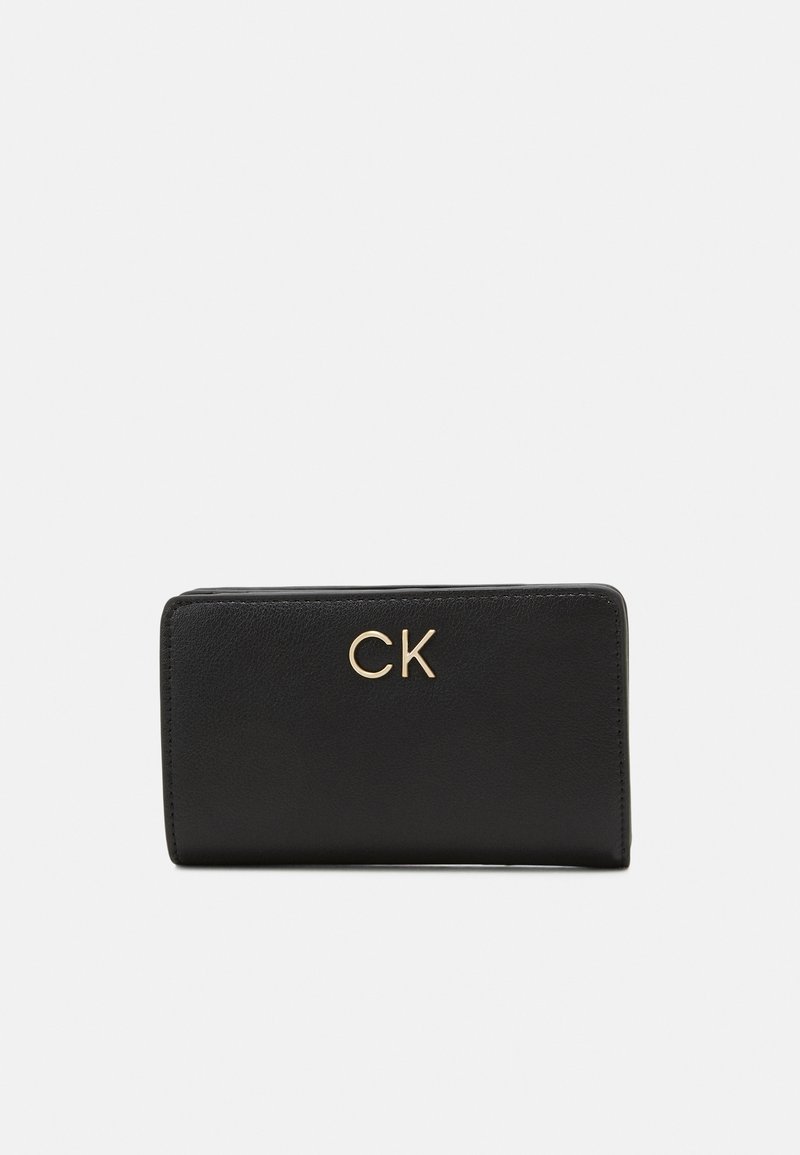 Black leather wallet with a smooth texture, featuring a gold "CK" logo on the front. Compact rectangular shape with rounded edges.