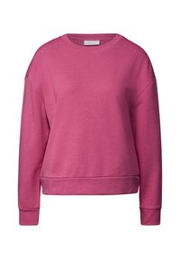 Sweatshirt rose avec un col rond, des épaules tombantes et des clous décoratifs sur les épaules. Il présente des poignets et un ourlet côtelés.