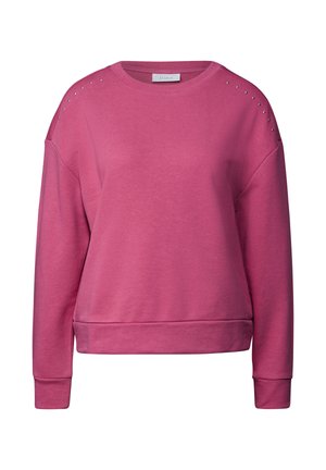 Vaaleanpunainen huppari, jossa on pyöreä kaula-aukko, pudotetut olkapäät ja koristeelliset niitit olkapäissä. Varusteena ribbireunat hihoissa ja helmassa.