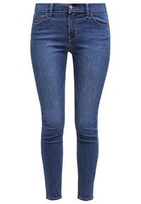 Jean en denim bleu slim fit avec bouton et fermeture éclair à l'avant, poches avant et arrière, et décoloration subtile sur les cuisses et les genoux.
