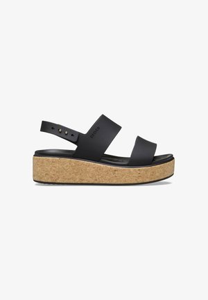 Black platform sandals with cork soles and wide straps. Features adjustable back strap and textured footbed for comfort.