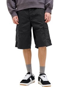 Black cargo shorts made from durable fabric, featuring multiple pockets, a relaxed fit, and knee-length design, paired with black sneakers.