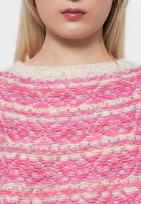 Knitted sweater in cream and shades of pink, featuring a textured pattern with alternating horizontal stripes and a round neck.