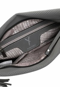 Grey perforated bag with a zip closure. Interior features a smooth grey lining with printed text and a zip pocket with logo accents.