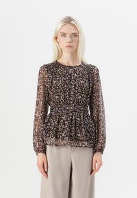 Svart blommig blus med långa ärmar, genomskinligt tyg, sammanknuten midja och ömtåliga mönster i rosa, grönt och beige. Matchad med ljusgrå byxor.