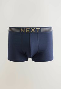 Boxer shorts en coton navy avec une ceinture rayée or et navy portant le logo « NEXT. » Texture lisse et design ajusté.