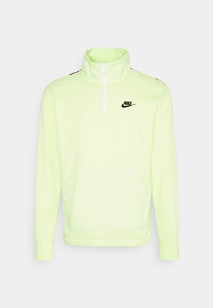 Neonově zelený pulovr Nike s vysokým límcem, zipem na půl, dlouhými rukávy a přední kapsou. Černý akcent loga na hrudi.