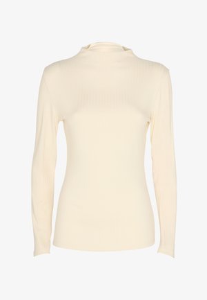 Maglietta a maniche lunghe di colore crema con un collo alto e una silhouette aderente, presentata su uno sfondo bianco.