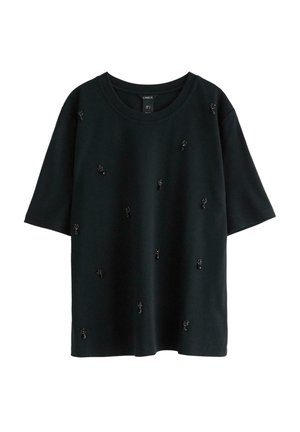 T-shirt nera a maniche corte con collo tondo e piccoli ornamenti floreali in perle nere e paillettes sparsi sulla parte anteriore.