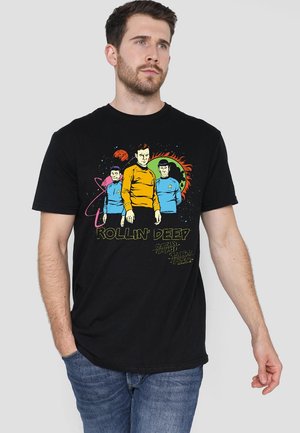 Black cotton t-shirt featuring colorful graphic design with three figures in space attire and the text "ROLLIN' DEEP." Short sleeves, crew neck.