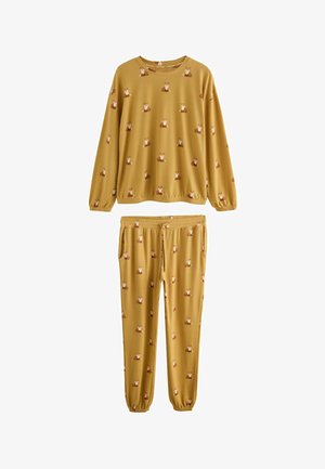 Gelbes Pyjama-Set mit einem Fuchs-Muster. Langärmliges Oberteil mit elastischen Bündchen, passende Hose mit Taschen und elastischem Bund.