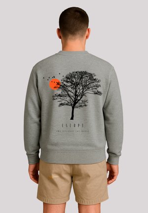 Gray sweatshirt featuring a black tree graphic, an orange sun, and birds. The design includes the text "ESCAPE" beneath the tree.