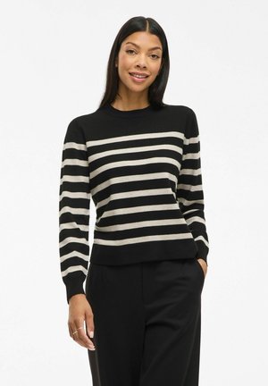 Maglione a righe nero e beige con maniche lunghe e scollatura tonda, caratterizzato da un orlo dritto e una texture morbida lavorata a maglia.