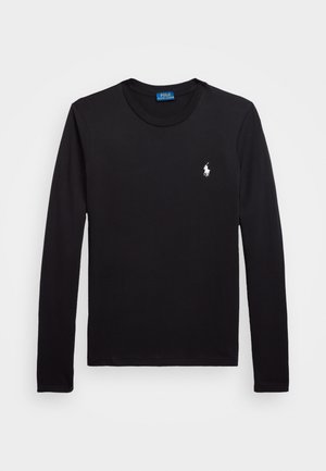 Musta pitkähihainen t-paita, joka on valmistettu puuvillasta. Siinä on pyöreä kaula-aukko ja pieni valkoinen polo-logo vasemmassa rintamuksessa. Silkkinen pinta.