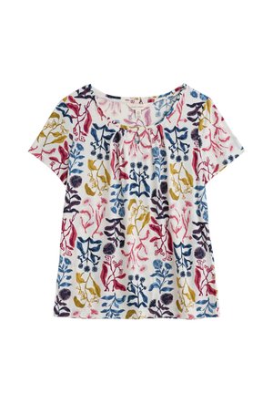 Blouse blanche à manches courtes avec un motif floral abstrait coloré en rouge, bleu, jaune et violet, avec un col froncé.