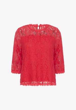 Haut en dentelle rouge avec des manches trois-quarts, des bords festonnés et un dos en keyhole. Présente des motifs floraux sur l'ensemble du tissu.