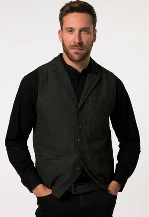 Dark gray herringbone vest with five buttons, notch lapels, and one chest pocket, worn over a black long-sleeve shirt.