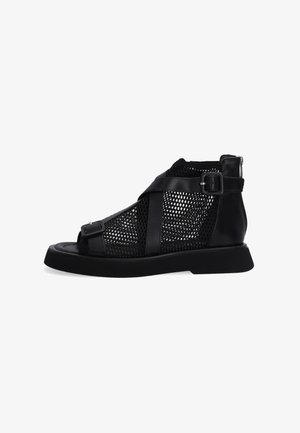 Black mesh ankle boots with synthetic leather accents, open-toe design, contrasting straps, and a flat rubber sole. Side zipper closure.