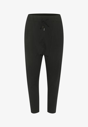Sorte svedbukser lavet af blødt stof, med elastisk talje med snor, tætsiddende ben og en asymmetrisk sømdesign.