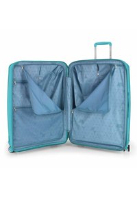 Valigia rigida di colore turchese, con un ampio interno foderato in tessuto blu con motivo geometrico, numerose tasche con cerniera e una maniglia retrattile.