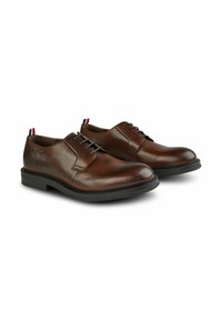 Chaussures en cuir marron avec une finition lisse, semelle en caoutchouc noire et un design classique à lacets. Comprend des accents décoratifs sur le talon.
