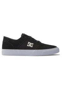 Black low-top sneakers with a suede and canvas upper, featuring a white logo on the side and a rubber sole with a textured pattern.