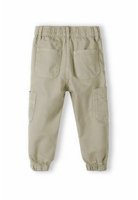 Ljust beige cargobyxor i mjukt, texturerat tyg, resårmidja och fyra fickor med elastiska muddar vid anklarna.