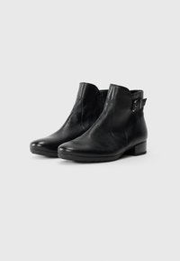 Pair of black leather ankle boots with side zipper and decorative buckle, low block heel, on a plain white background.